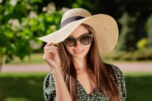 A lady wearing sunglasses smiling
