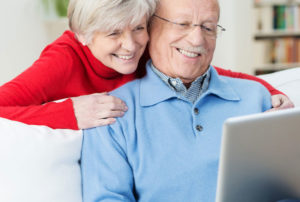 a man and a woman looking at a laptop